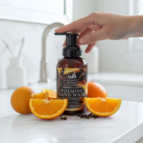Orange & Clove Foaming Hand Wash with oranges and cloves on counter